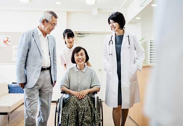 Woman checking out of hospital in wheelchair